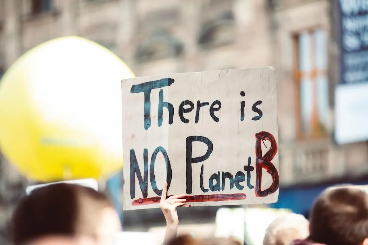 A placard about the importance of saving the earth during a demonstration creating awareness for others.