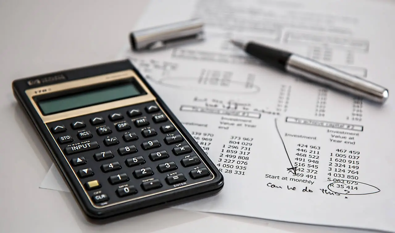 Financial reports and a calculator showing business management with budget.