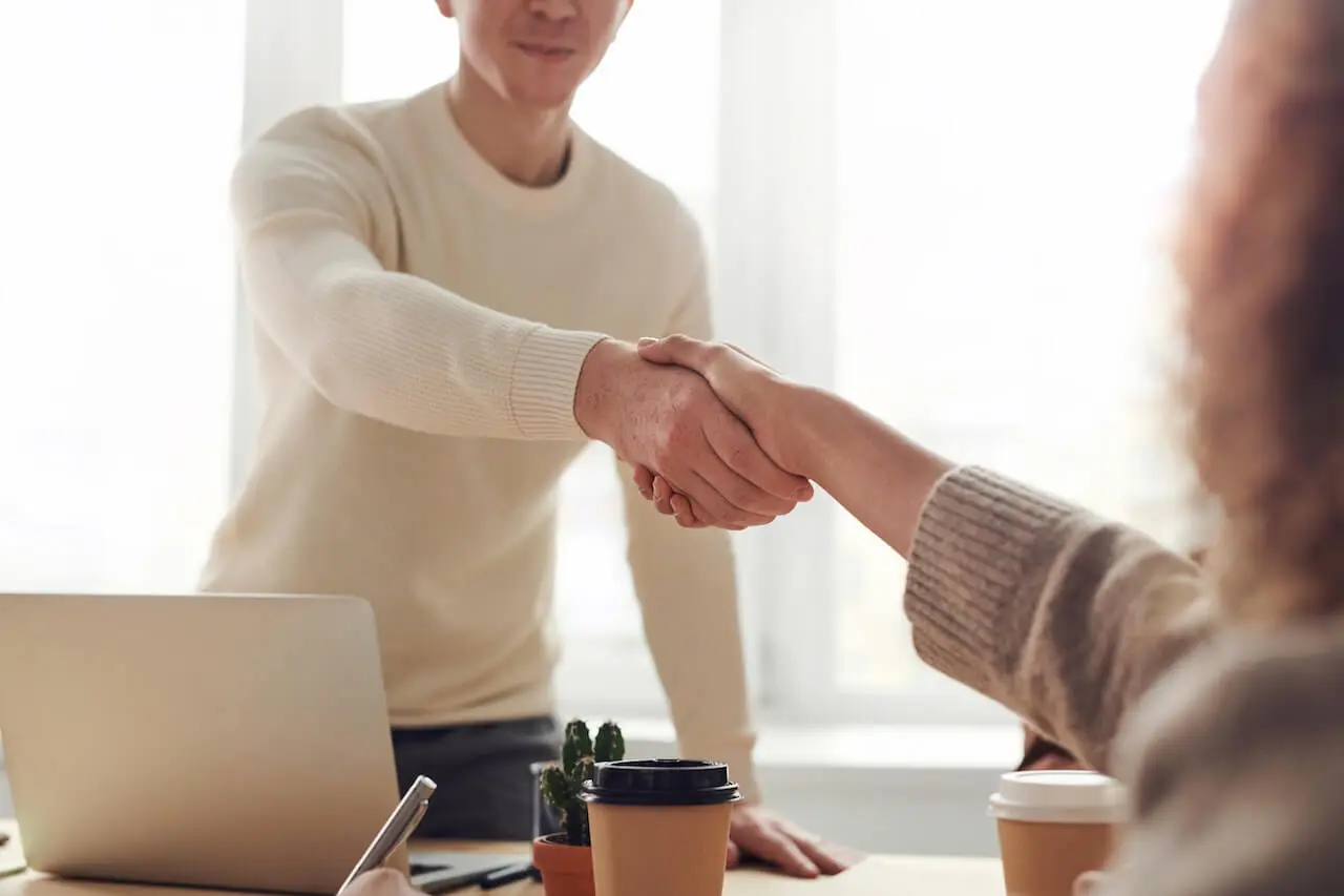 Two people shaking hands and building business relationships