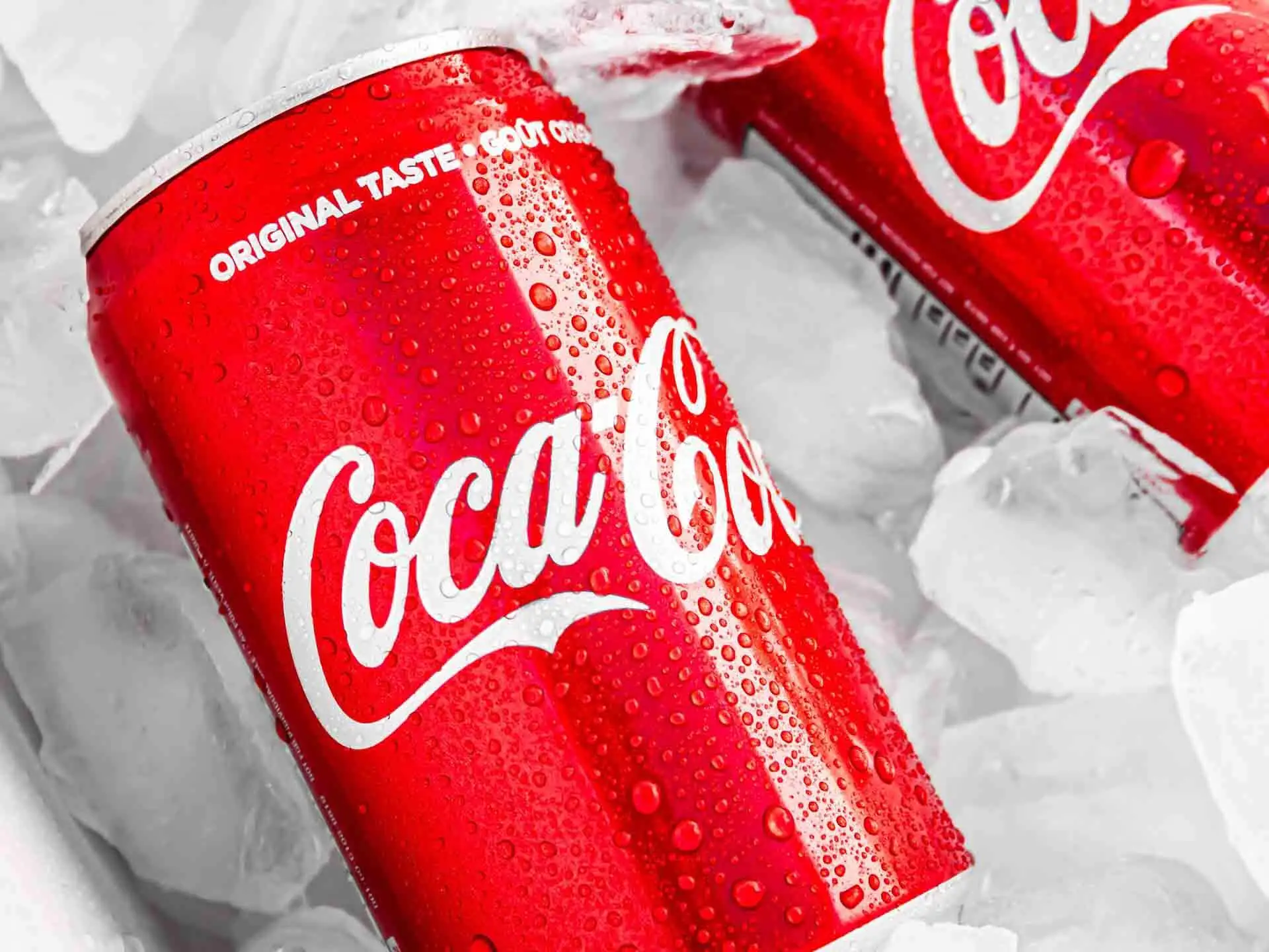 Cans of Coca Cola on white plastic pack as iconic and successful branding sample