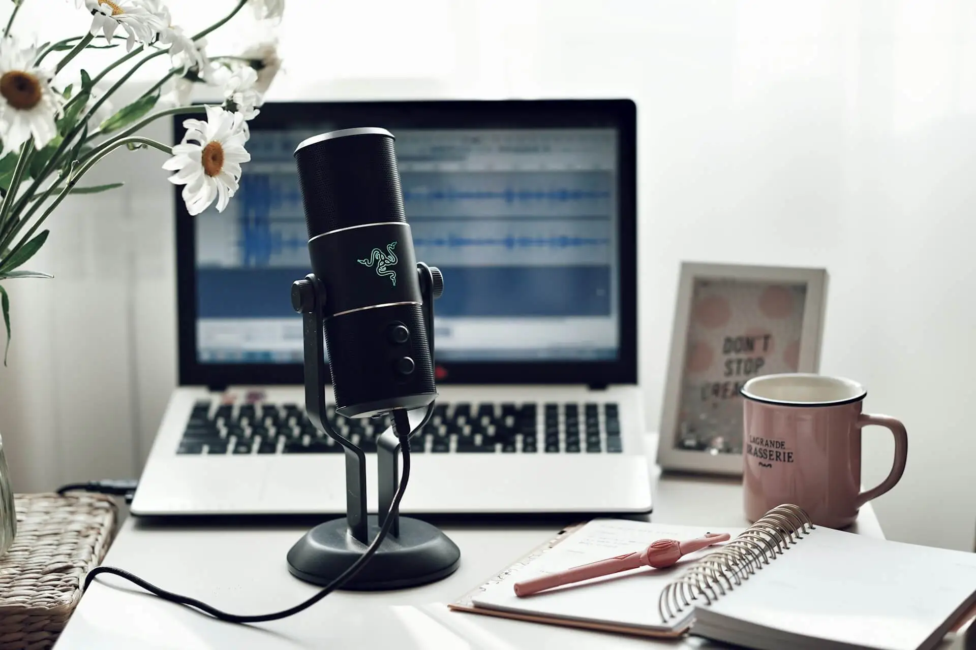 Black microphone on white paper used for recording podcasts