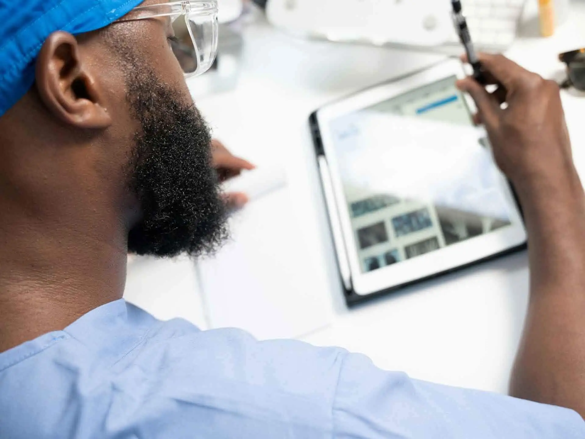 A man using a tablet showing an aspect of health insurance content marketing services