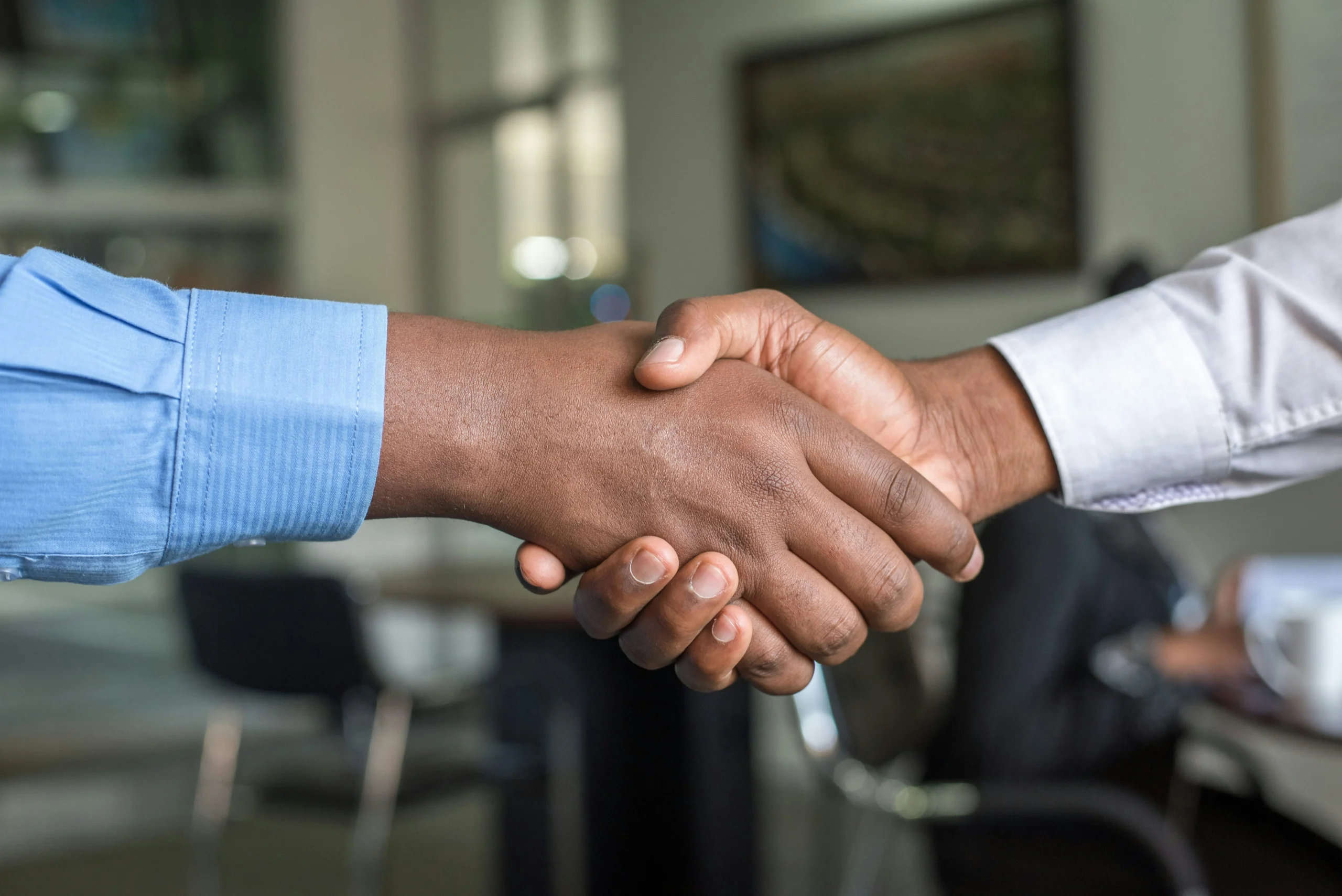 Business handshake representing trust and LLMs-driven brand partnerships