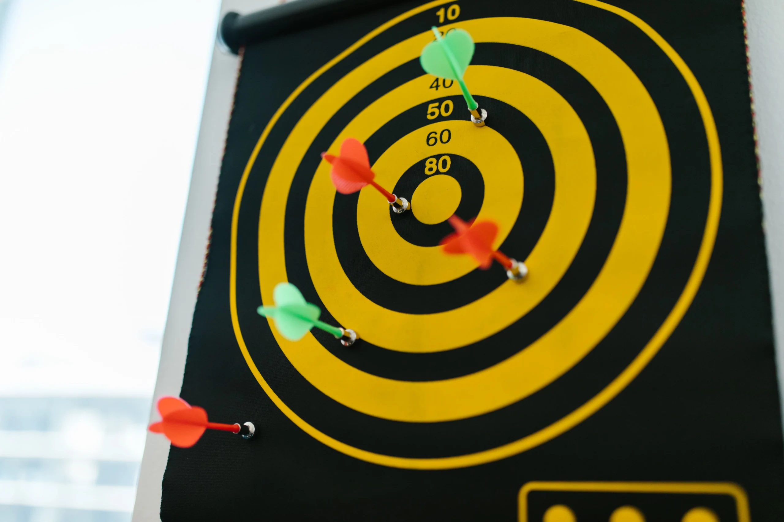 Yellow and black target dartboard representing B2B audience targeting and lead qualification metrics.